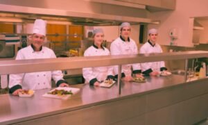 four happy food court attendants at work